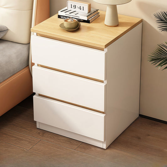Modern white bedside table with light wood top, digital clock, lamp, books, and cup of coffee
